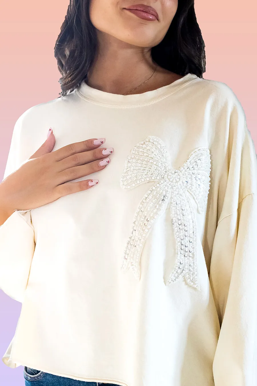 maglia over con fiocco a paillettes